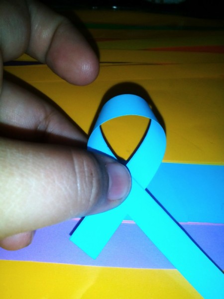 Folded Paper Stars in a Jar - carefully tie one of a strip into a knot