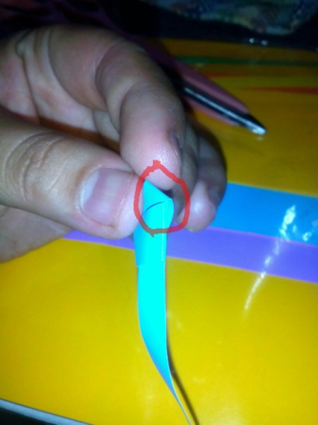 Folded Paper Stars in a Jar - carefully pull paper to tighten knot leaving no open space between 5 corners