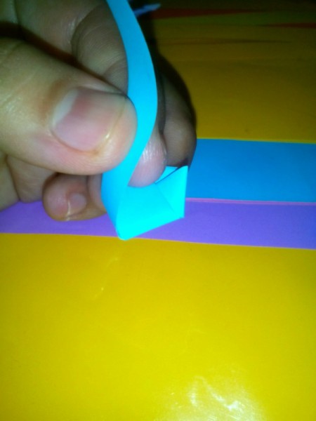 Folded Paper Stars in a Jar - wrap rest of strip around the knot