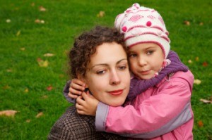 Mother and Daughter Hugging in Park