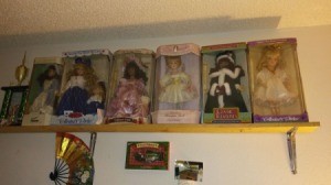 Value of Porcelain Dolls - boxed dolls on a shelf