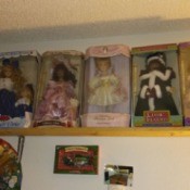 Value of Porcelain Dolls - boxed dolls on a shelf