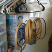 Use Hangers to Store Embroidery Hoops - hoops hung on a hanger with paper clips