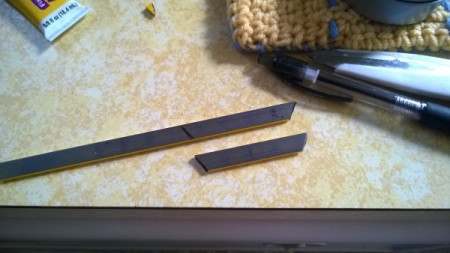 A magnet strip being cut to fit a spice container.