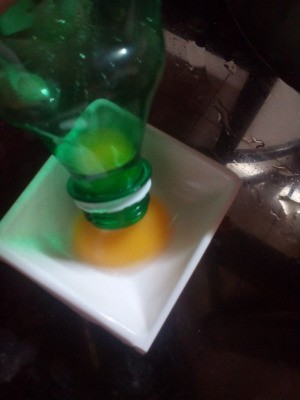 Separating an egg yolk, using a plastic bottle.