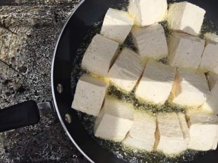 Stuffed tofu frying in pan