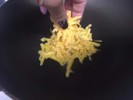 placing cheese in pan