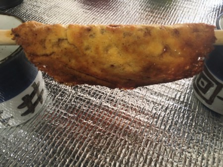 melted cheese over wooden spoon