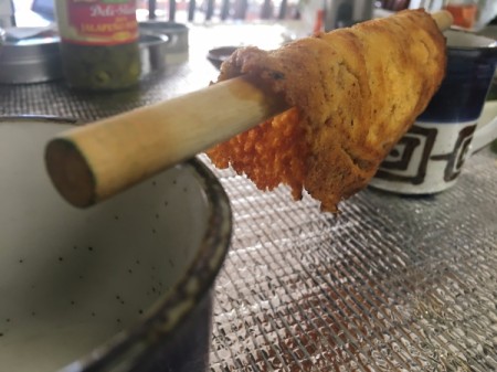 melted cheese over wooden spoon