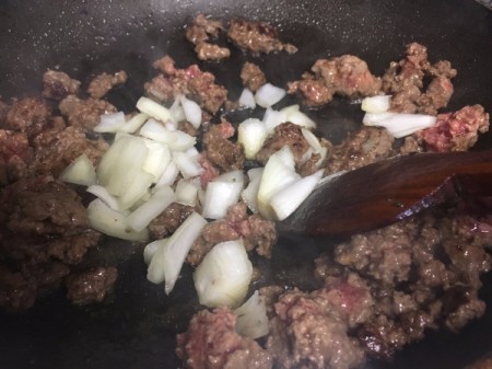 coking burger and onion in pan