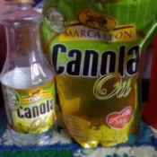 A bottle of canola oil next to a refill pack.