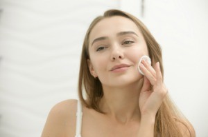 Woman Applying Witch Hazel to Her face