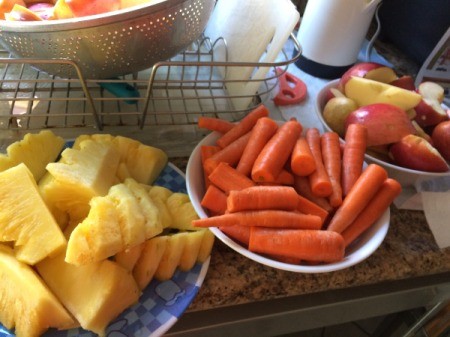 cut pineapple, carrots, and apple quarters