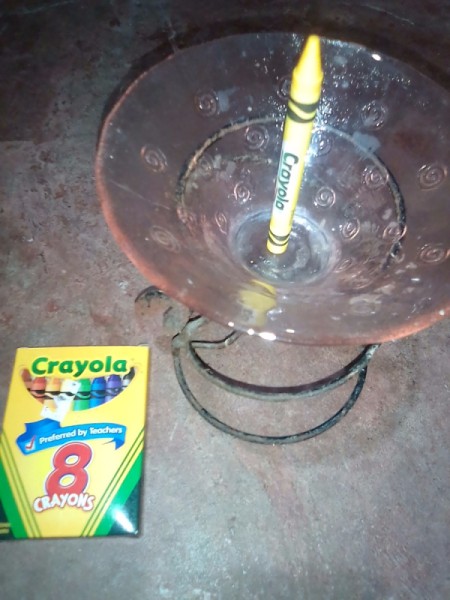 A crayon in a candle holder.