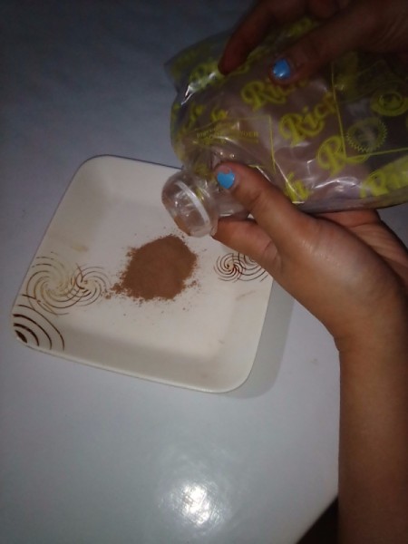 A makeshift closure to a plastic bag, using a bottle top and cap.