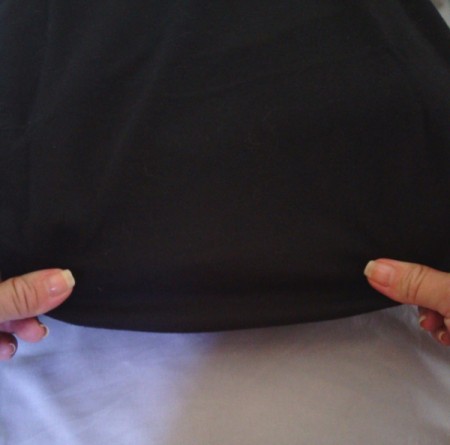 Tucking in the t-shirt material around the pillow.