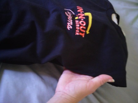 A black T-shirt from In-N-Out Burger with a pillow tucked inside.