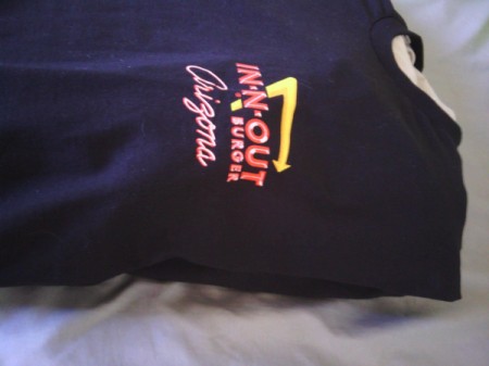 A black T-shirt from In-N-Out Burger with a pillow tucked inside.