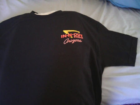 A black T-shirt from In-N-Out Burger with a pillow tucked inside.