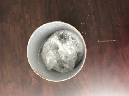 Bubbled wrapped valuables in a recycled food container.