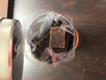 Chocolate at the top of a food container filled with valuables.