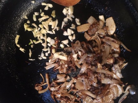 adding garlic to fried onions