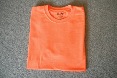 A perfectly folded orange T-shirt.