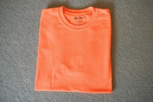 A perfectly folded orange T-shirt.