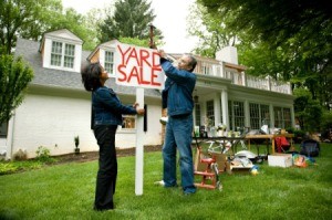Couple Putting up Yard Sale Sign