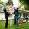 Couple Putting up Yard Sale Sign