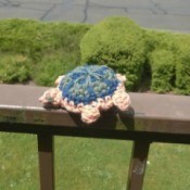 Crocheted Turtle - turtle on balcony railing