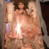Value of Porcelain Doll - doll wearing pink dress in box