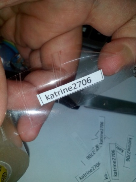 Printed name labels being adhered with tape.