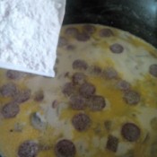 adding flour to pan