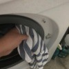 Wiping down the gasket in a washing machine door.
