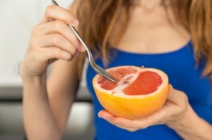 Woman Eating Grapefruit