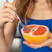 Woman Eating Grapefruit