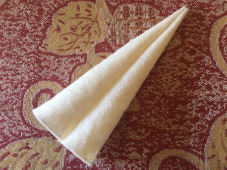 DIY Unicorn Headband - cut out fabric and begin rolling into the horn shape