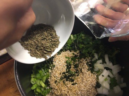 adding herbs to pot