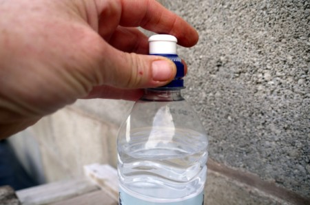DIY Outdoor Plastic Bottle Handwashing Station - putting lid on