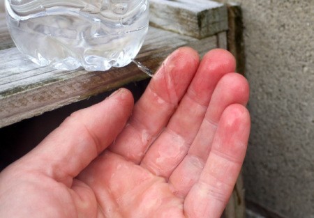 DIY Outdoor Plastic Bottle Handwashing Station - water flowing on to palm of hand