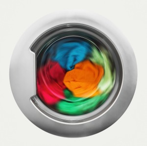 Colorful clothing in a washing machine.