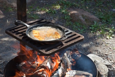Cooking over a camp fire.