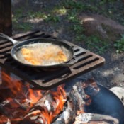 Cooking over a camp fire.