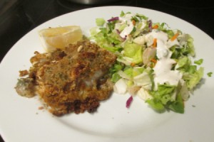 Creamy Caesar Herb Crusted Haddock on plate with salad