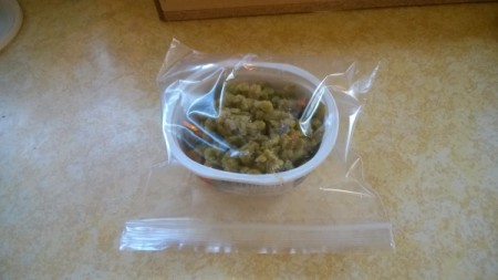 A recycled container inserted into a ziptop bag.