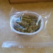 A recycled container inserted into a ziptop bag.