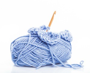 A skien on yarn and a crochet hook.