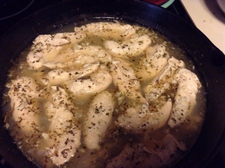 Simmering the chicken in the champagne mixture.