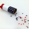 A confetti launcher made from a toilet paper tube, decorated in red, white and blue for the 4th of July.